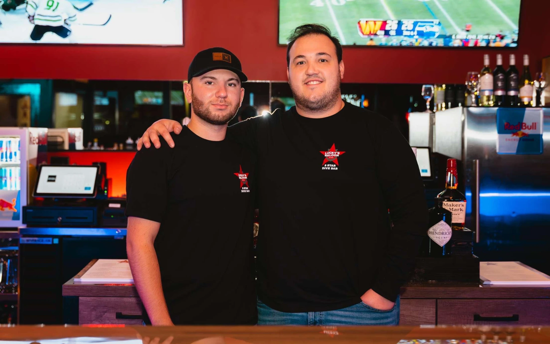 Two Lucky's Saloon staff members behind the bar