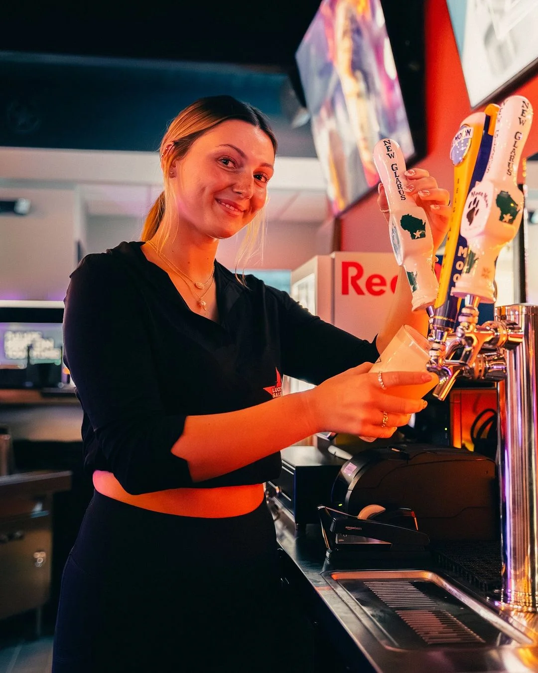Bartender pouring a fresh draft beer at Lucky’s Saloon
